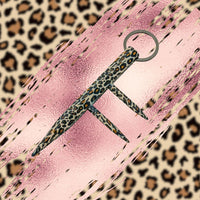 leopard print three spiked kubaton keychain on pink animal print background