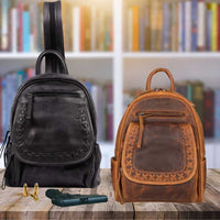 black-and-cognac-daisy-leather-conceal-carry-backpacks-on-wood-table