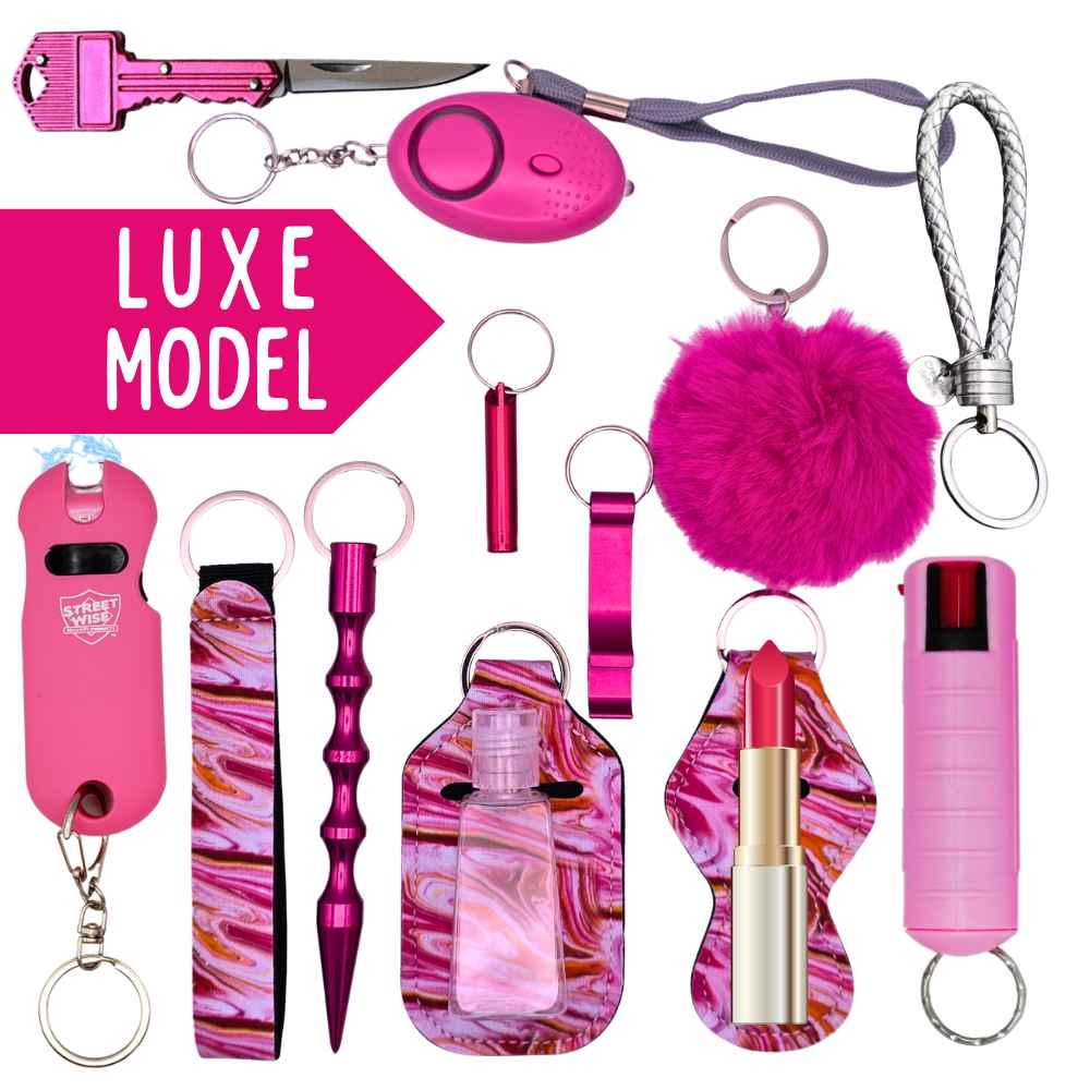 Collection of pink keychains and self-defense items with 'LUXE MODEL' text on a white background.