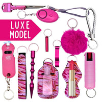 Collection of pink keychains and self-defense items with 'LUXE MODEL' text on a white background.