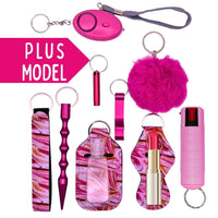 Collection of pink keychains and self-defense items on a white background