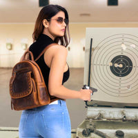 woman-wearing-cognac-daisy-lether-conceal-carry-backpack-at-gun-range