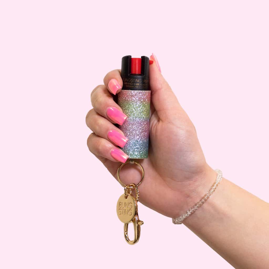 rainbow glow bling pepper spray keychain in hand